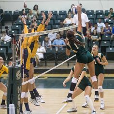 the volleyball players are playing volley ball on the court