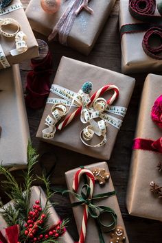 christmas presents wrapped in brown paper and tied with ribbons, candy canes and bows