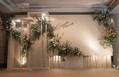 an indoor wedding setup with flowers and greenery