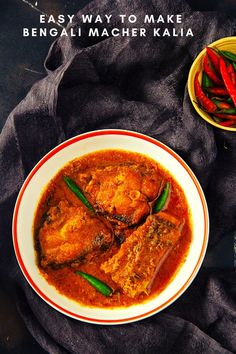 a white bowl filled with food on top of a black cloth next to bowls of red and green peppers