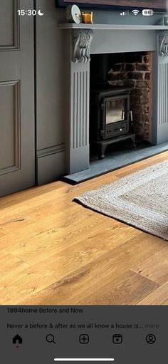 a flat screen tv sitting on top of a wooden floor next to a fire place