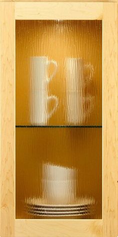 the reflection of a coffee cup in a glass case on a wooden surface with reflections