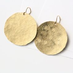 Disc Earrings, Raw Silk Dangle Earrings, Circle EarringsBold but minimalist, the simple lines of these large earrings are accentuated with a matte raw silk texture. Each disc is hand-sawn from brass sheet and given a raw silk texture, then hung on a gold filled ear wire. Details: - handmade from yellow brass- Gold filled earwires- Disc diameter measures approx 1-1/2"Ready to ship in 1 week via USPS with tracking and insurance. Your order from TorchFire Studio will arrive in a ribbon-topped gift Yellow Statement Earrings, Gold Disc Earrings, Dandelion Yellow, Silk Texture, Gift Baskets For Men, Earrings Circle, Earrings Handmade Dangle, Handmade Gifts For Her, Gold Disc