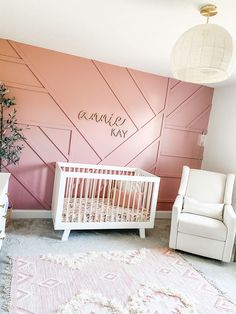 a baby's room with pink walls and white furniture in the foreground is a crib