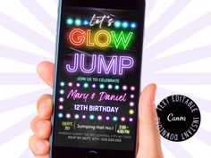 a person holding up an iphone with the glow crazy app on it's screen