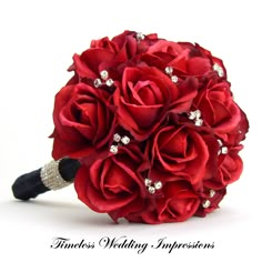 a bridal bouquet with red roses and crystals