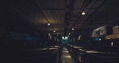 an empty train station with the lights on