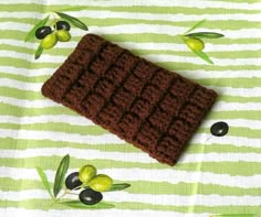 a brown crocheted dishcloth with olives on it