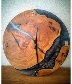 a clock made out of wood with blue hands