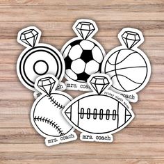 some stickers that are on top of a wooden table with balls and basketballs