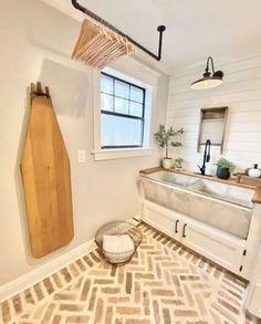 a kitchen with a sink, window and wooden utensils