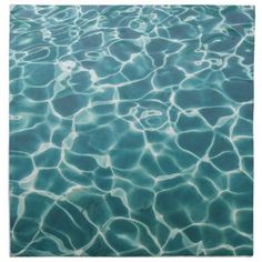 water ripples over the surface of a swimming pool in clear blue waters, as seen from above