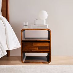 a night stand with two drawers on each side and a lamp on the other side