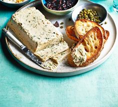 a plate with bread, crackers and other food on it