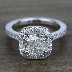 a cushion cut diamond surrounded by pave set diamonds