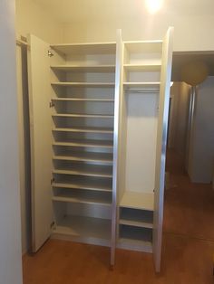 an empty closet is shown with white shelves