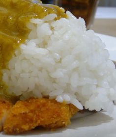 rice and chicken with gravy on a white plate