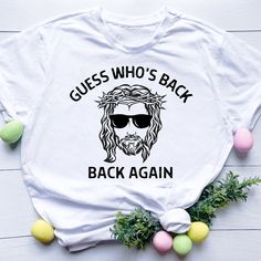 a white t - shirt with the words guess who's back back again on it