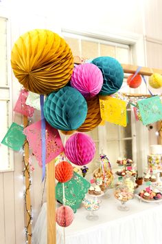 a table topped with lots of colorful paper decorations