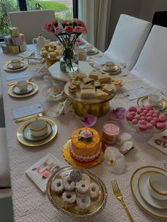 a table is set with desserts and plates