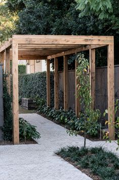 a wooden pergoline in the middle of a garden