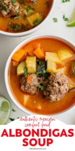 two bowls of soup with meat, pineapples and other vegetables on the side