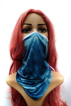 a mannequin head wearing a face mask with red hair and blue jeans on it