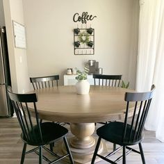 a kitchen table with four chairs around it