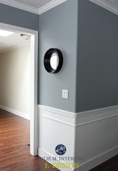 an empty room with wood floors and white trim on the walls, painted in light blue