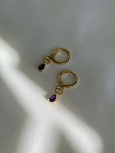 "18K gold plated teardrop amethyst, emerald drops huggie hoops which are beautifully shiny under the sunlight. *Nickel free 👀 Details 👀 * Materials : 18K gold plated brass, Amethyst, Emerald * Hoop style * 10mm hoop diameter (Inner diameter : 8mm) Crystal charm : 3 mm (w) x 6 mm (h) * Product is non-returnable for hygiene ⚠️Tips for caring⚠️ -Keep jewelry dry (Avoid contact liquid) -Store difference type of jewelry separately -Store jewelry in a small zip lock bag 📦 Packaging 📦 These earring Gold Plated Teardrop Huggie Earrings, Gold Plated Teardrop Huggie Earrings For Gift, Teardrop Gold Plated Huggie Earrings For Gift, Tarnish Resistant Teardrop 14k Gold Filled Huggie Earrings, Teardrop Hoop Earrings As A Gift, Teardrop Hoop Earrings Gift, Gold Plated Dangle Huggie Earrings For Gift, Gold Plated Dangle Huggie Earrings As Gift, Dainty Drop Hoop Earrings For Gift