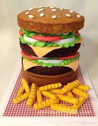 a giant hamburger and fries on a plate