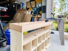 a garage filled with lots of boxes and shelves next to a toolbox full of tools