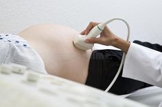 a pregnant woman is hooked up to an iv machine in her stomach royalty images and stock photos