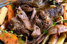 a close up of a plate of food with meat and vegetables