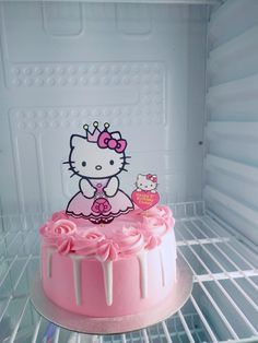 a hello kitty cake sitting on top of a refrigerator