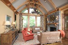 a living room filled with furniture and a fire place in the middle of a room