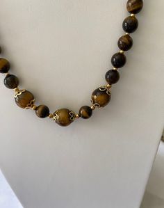 There is Wow Chatoyancy in this Beautiful Tiger's Eye Necklace and Earrings Set,  This is a Unique Jewelry Piece, it has Golden Stainless-Steel Bead Spacers and Comes with a Stainless-Steel 18K Gold Plated Lobster Claw Clasp and Paperclip Chain and Ear Wires,  The Lovely Beads are Graduated from Small to Large for a Comfortable Neckline, The Gorgeous Beads are Yellow and Reddish Brown, with the Rolling Phenomenon Chatoyancy!, You will find the 3 Large 14mm Stones in the Front of the Necklace, surrounded by Different Style Bead Caps for Each One, It is a Stunner  for sure, it is Hypoallergenic for Sensitive Neck and Ears, The Dangle Earrings are on 18K Gold-Plated Stainless-Steel Ear Wires , The Paperclip Chain is Fully Adjustable with each large link of the chain and Large Comfortable Lobs Art Jewelry Design, Tigers Eye Necklace, Brown Necklace, Tigers Eye Gemstone, Eye Necklace, Minimalist Necklace, Tiger Eye, Paper Clip, Gifts For Wife