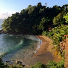 the beach is surrounded by trees and water