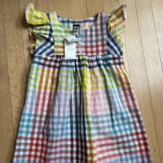 Adorable And Colorful Woven Dress Cute Multicolor Flutter Sleeve Dress, Playful Yellow Short Sleeve Dress, Plaid Cotton Dress For Playtime, Multicolor Flutter Sleeve Dress For Playtime, Multicolor Cotton Dress For Playtime, Yellow Summer Play Dress, Yellow Summer Dress For Play, Casual Multicolor Dress For Playtime, Casual Multicolor Dress For Play