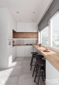 the kitchen is clean and ready to be used for cooking or eating, with stools at the counter