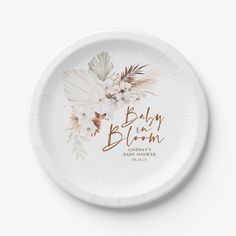 a paper plate with the words baby in bloom printed on it