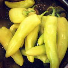 some yellow peppers are in a pot on the stove