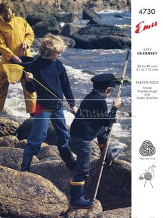 two young boys fishing on the rocks by the ocean while another boy watches from behind them