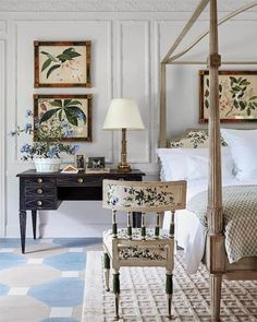 a bed room with a neatly made bed next to a desk and chair in it