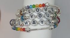 "Memory Wire Bracelet Always Love you Tribute bracelet for the one you love! Made with fine Czech beads and metal spacer beads. This would be a great lovers gift, gift for girlfriends, gift for mom, or BFF! Jewelry gifts are always appreciated and this piece of statement jewelry says just how you feel. Rainbow bracelets are great for showing pride and this memory wire bracelet is a charm among whimsical bracelets and charm bracelets alike. Love jewelry comes from the heart. The bracelet was made Personalized Inspirational Silver Beaded Bracelets, Inspirational Silver Beaded Friendship Bracelets, Inspirational Personalized Silver Beaded Bracelets, Bff Jewelry, Bracelet Rainbow, Memory Wire Bracelet, Jewelry Post, Love Jewelry, Rainbow Bracelet