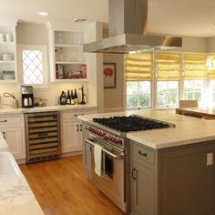 a kitchen with an island, stove and sink