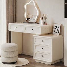 a white dressing table with a mirror and stool