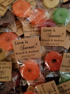 there are lots of candy candies in the bag with love is sweet written on them