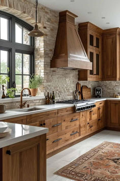 Rustic kitchen with wood cabinetry, exposed brick backsplash, farmhouse range hood, and natural textures for a warm and inviting atmosphere. Beautiful Wood Kitchen Cabinets, Tuscan Home Design, Rustic Interior Design Kitchen, Modern Tuscan Home Interiors, Wood Stain Kitchen Cabinets, Modern Rustic Kitchen Cabinets, Rustic Kitchen Cabinets Farmhouse Style, Kitchen Ideas Wood Cabinets, French Kitchen Ideas