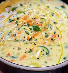 a pot filled with soup and vegetables on top of a table